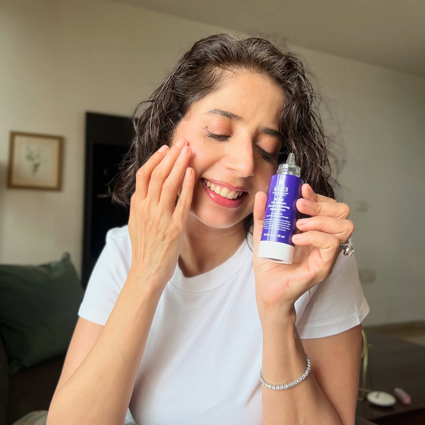 Aiana holding a Kiehl's retinol night serum